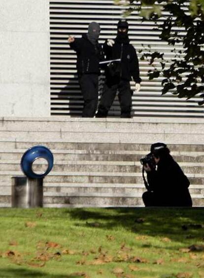 Un <i>ertzaina</i> fotografía, el domingo, la papelera donde se hallaba la segunda bomba colocada en los juzgados de Getxo.