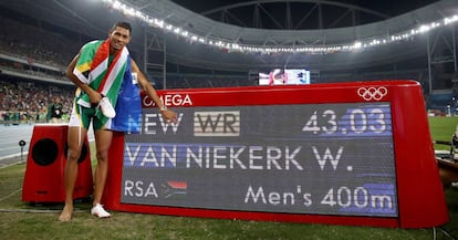 Van Miekerk posa junto al marcador que registra su r&eacute;cord del mundo en los 400 metros lisos.