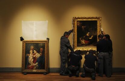 Un grupo de operarios en la exposición de El Prado 'Rembrandt, pintor de historias'.