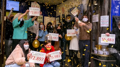 Workers at Madrid's famous "Doña Manolita" lottery sales agency celebrating the fact that they sold 'décimos' from this year's first and third prizes.