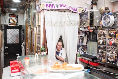 Mari, the co-owner of the bar, takes care of the cooking while her husband serves customers at the bar.