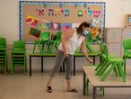 Una profesora prepara un aula para los alumnos que se reincorporan clase tras el confinamiento, el jueves en Haifa.