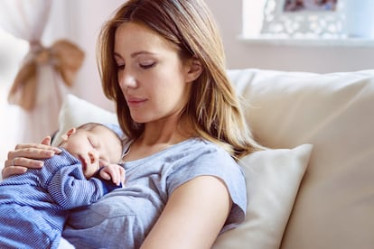 Portrait of a beautiful young mother with newborn baby