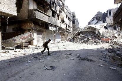 Un hombre cruza la calle en el campo de refugiados de Yarmuk, en Damasco, la capital siria. 