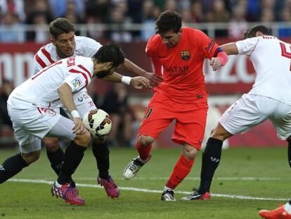 Messi prova de controlar la pilota, envoltada de jugadors del Sevilla.