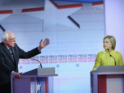 Hillary Clinton escucha una intervenci&oacute;n de Bernie Sanders.