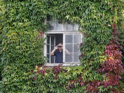 Un vecino local hace una fotografía desde su ventana mientras la canciller alemana Angela Merkel hace campaña para las elecciones del domingo en Giessen (Alemania).