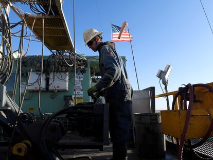 A worker operates equipment on a drilling rig near Midland, Texas, on February 12, 2019.