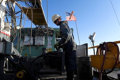 A worker operates equipment on a drilling rig near Midland, Texas, on February 12, 2019.