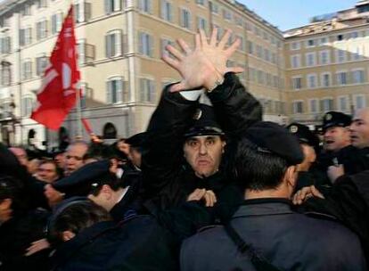 GUARDIAS CONTRA POLICÍAS. La policía trata de contener a los guardias de seguridad que se manifestaron ayer en Roma contra la propuesta de convertir su empresa en una cooperativa.