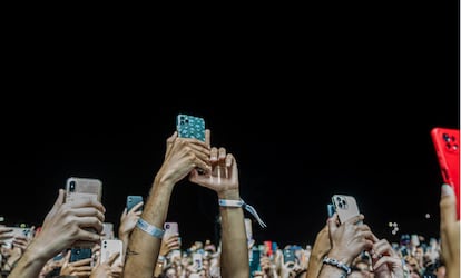 Cell phones held aloft during a concert. 