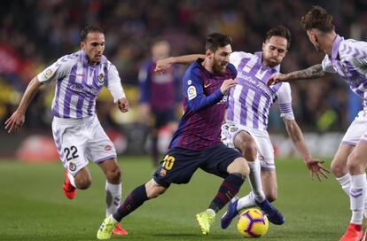 Lionel Messi, en el centro, se enfrenta al jugador del Valladolid Nacho Martínez.