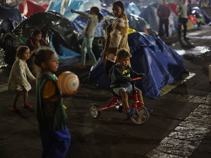 Migrant children from Venezuela play outside Our Lady of Solitude church as they camp with their families waiting for an appointment through the U.S. Customs and Border Protection app, called CBP ONE, in Mexico City, Mexico November 23, 2023