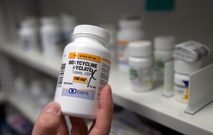 A pharmacist holds a bottle of the antibiotic doxycycline hyclate in Sacramento, Calif., July 8, 2016