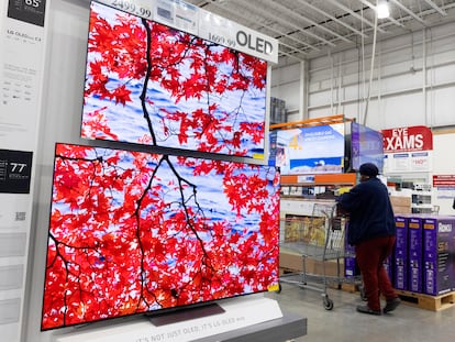 A customer walks past televisions at a Costco in Washington, DC, USA, 22 February 2024.