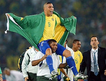 Cafú levanta la Copa del Mundo, mientras debajo de él, los brasileños se abrazan eufóricos por el título.