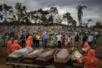 Un grupo de personas asiste a un sepelio en una tumba colectiva, el 23 de abril de 2020, en un área abierta en el cementerio Nossa Senhora Aparecida, en la ciudad de Manaos, Amazonas.