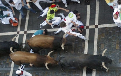 Runners falling to the ground during an encierro in 2005.