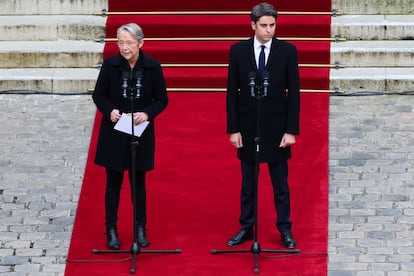 France's outgoing Prime Minister Elisabeth Borne delivers a speech next to newly appointed Prime Minister Gabriel Attal during the handover ceremony in Paris, France, on January 9, 2024. 