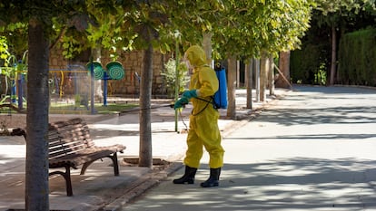 A worker disinfects an area near a senior home in Burbáguena, Teruel.