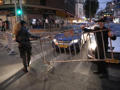 Policías israelíes instalan un puesto de control en la ciudad ultraortodoxa israelí de Bnei Brak al anochecer del martes.