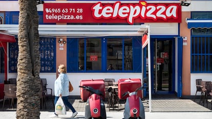 A pedestrian walks past the Spanish fast-food restaurant