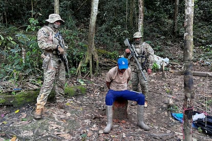 Brazilian officers arrest an illegal miner in Brazil.