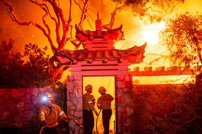 Firefighters battling the Palisades Fire west of L.A.