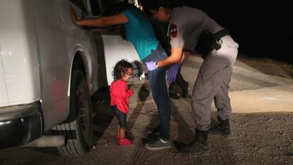 Una niña hondureña llora mientras su madre es cacheada por la patrulla fronteriza en McAllen (Texas), en 2018.
