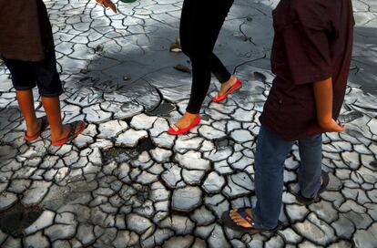 Tourists walk on dried mud at the Lapindo mud field in Sidoarjo, October 11, 2015.         REUTERS/Beawiharta    SEARCH "THE NATURAL WORLD" FOR ALL 20 IMAGES 