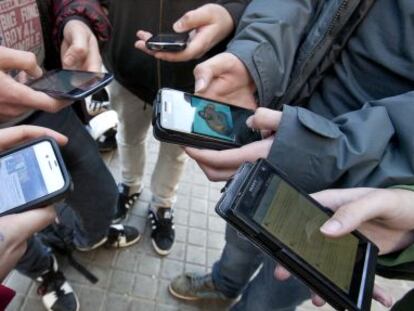 Jóvenes conectados a sus móviles, en 2013.
