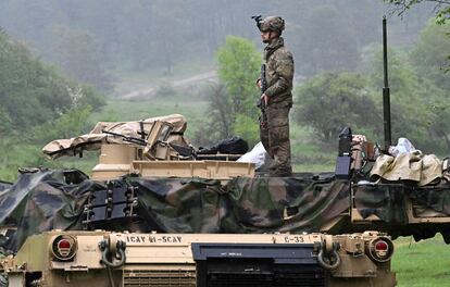 A US soldier stands on a US Army M1A2 Abrams tank during the Combined Resolve 18 exercise at the Hohenfels trainings area, southern Germany, on May 11, 2023.