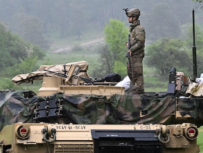 A US soldier stands on a US Army M1A2 Abrams tank during the Combined Resolve 18 exercise at the Hohenfels trainings area, southern Germany, on May 11, 2023.