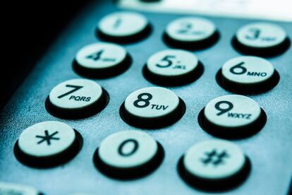 Close-up of numbers on landline phone.