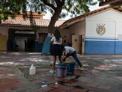 Dos niños se lavan las manos con el agua que sacan del pozo profundo en el colegio Rafael Salazar Brito de Margarita.