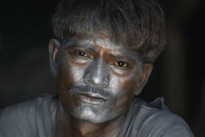 Un trabajador indio posa con la cara manchada de pólvora por hacer galletas de fuego para el festival hindú Diwali, en una fábrica a las afueras de Ahmadabad (India).