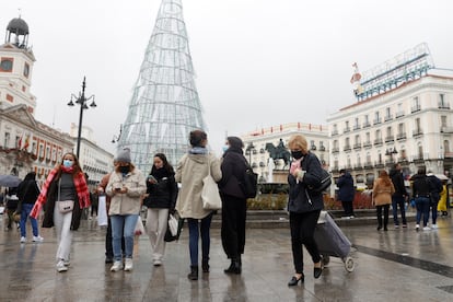 Varias personas caminan con mascarillas por la Puerta del Sol este viernes.