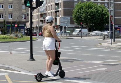 Una mujer circula con patinete eléctrico y casco, este miércoles en Vitoria. 