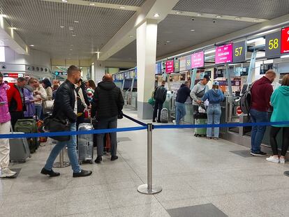 Queues of people waiting at check-in counters at Moscow airport on Wednesday.