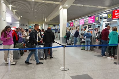 Queues of people waiting at check-in counters at Moscow airport on Wednesday.