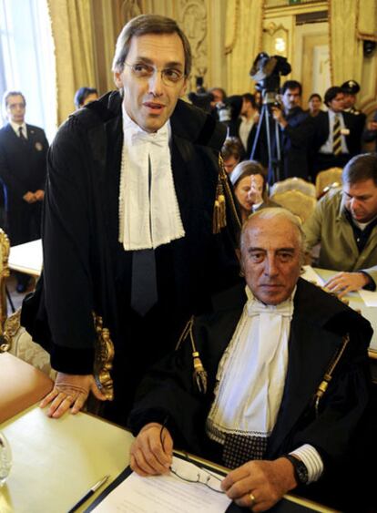 Ghedini, de pie, junto al también abogado y diputado Pecorella.