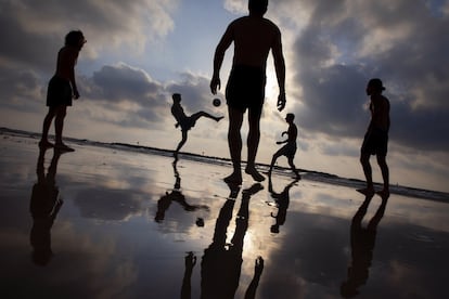 Un grupo de jóvenes juegan al fútbol en una playa de Tel Aviv, en Israel.