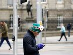 A man looks at his phone in Dublin as the spread of the coronavirus disease (COVID-19) continues, Dublin, Ireland, March 31, 2020. REUTERS/Jason Cairnduff