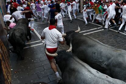 Los toros de la ganadería de José Escolar enfilan la calle Estafeta tras pasar la curva de Mercaderes, este sábado.