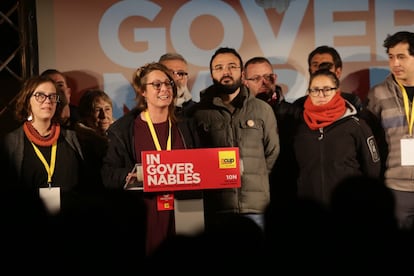 Two new deputies of the pro-independence far-left party CUP, Mireia Vehí (center) and Albert Botrán (second from the left) at the party's headquarters in Barcelona.
