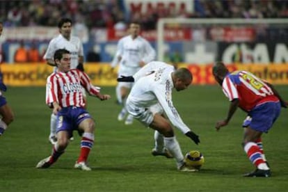 Ronaldo intenta regatear a Perea, con Antonio López a su espalda.