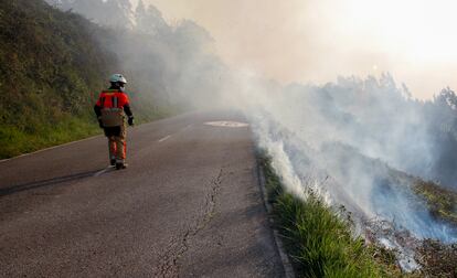 Un bombero observa la columna de humo del incendio registrado en el monte Naranco de Oviedo a finales de marzo.