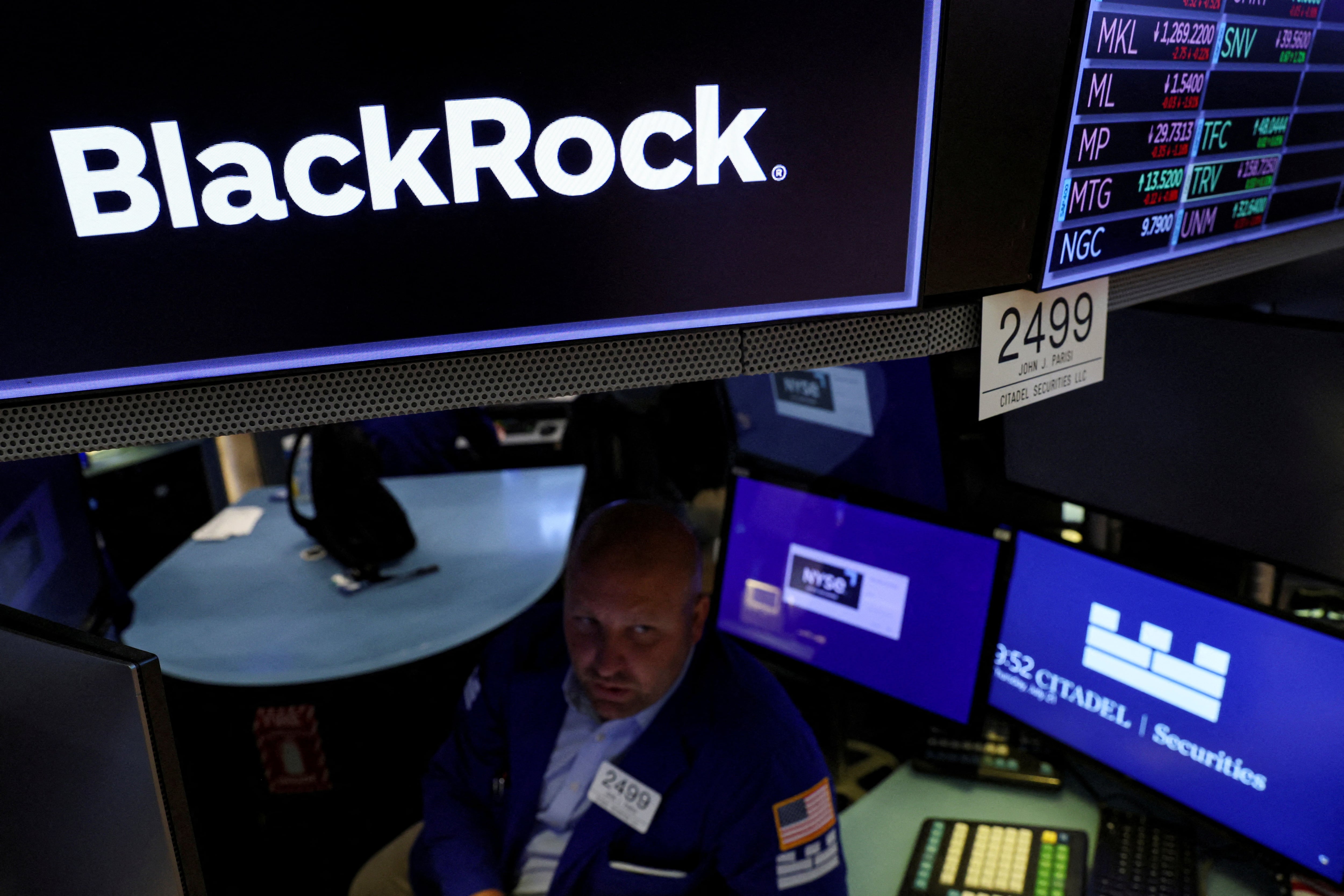 FILE PHOTO: A specialist trader works at the post where BlackRock is traded on the floor of the New York Stock Exchange (NYSE) in New York City, U.S., July 21, 2022. REUTERS/Brendan McDermid/File Photo