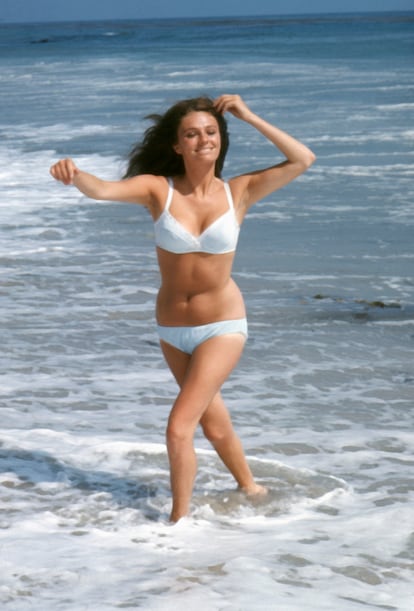 Jacqueline Bisset wearing a white bikini in surf, circa 1970 (Photo by Screen Archives/Getty Images).