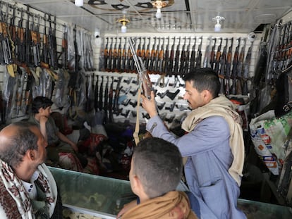 An arms dealer inspects a rifle at his shop, as the war in Gaza and the U.S.-led strikes on Houthi targets raise demand for firearms, in Sanaa, Yemen March 6, 2024.